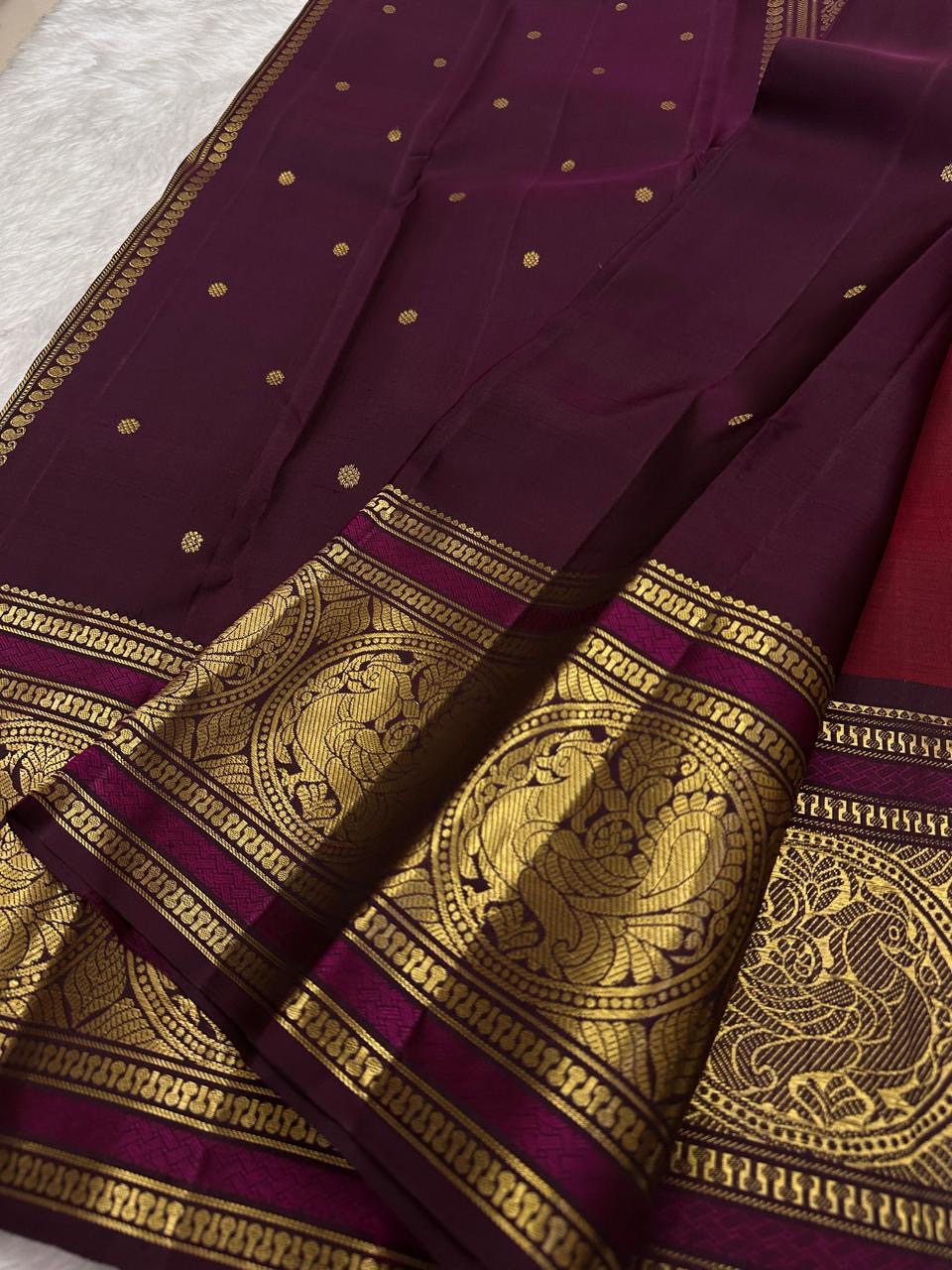 Ruby red Kanchipuram silk saree with sorgavaasal mayil border detail