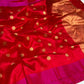 Open drape of ruby red Chanderi saree with gold-toned floral buttas and vivid pink borders.