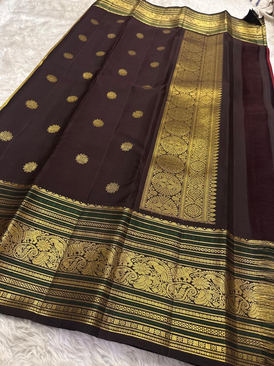 Ruby red Kanjeevaram saree yali motif zari detail on Korvai border