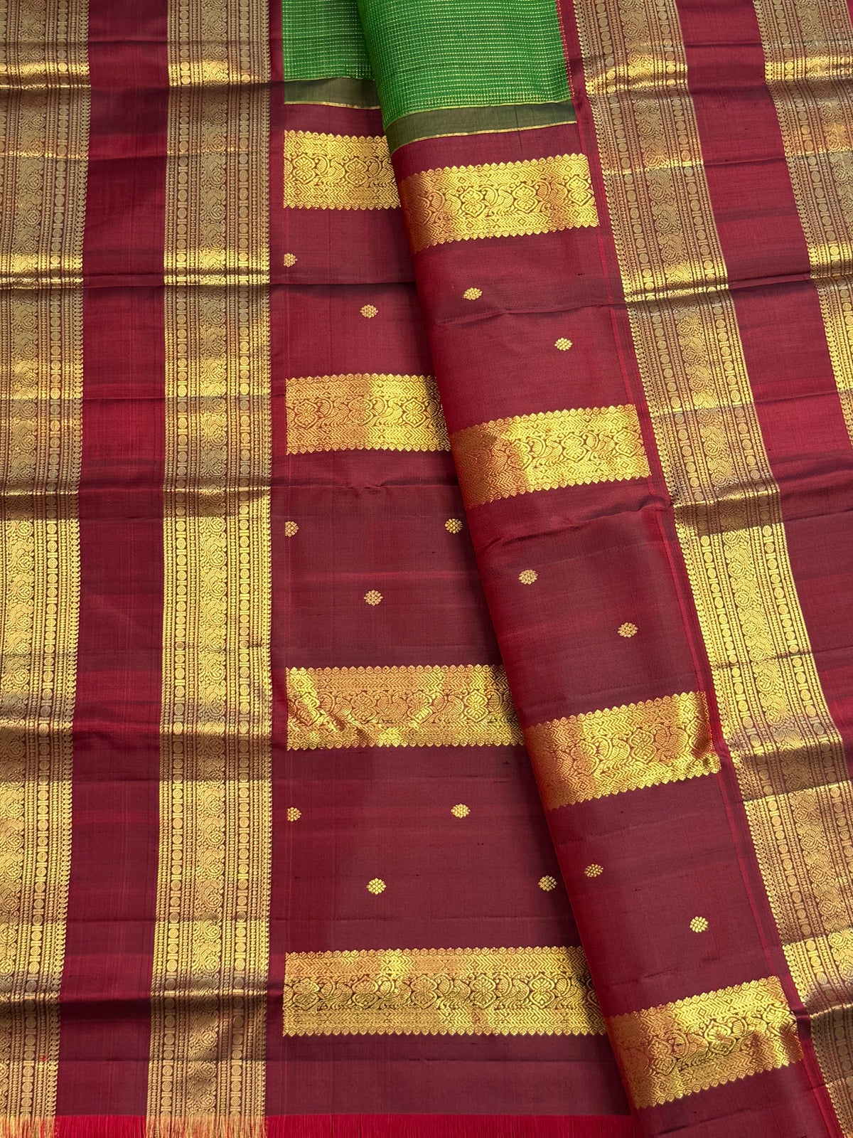 Rudraksham Pet gold zari border detail on leaf green Kanchipuram silk saree