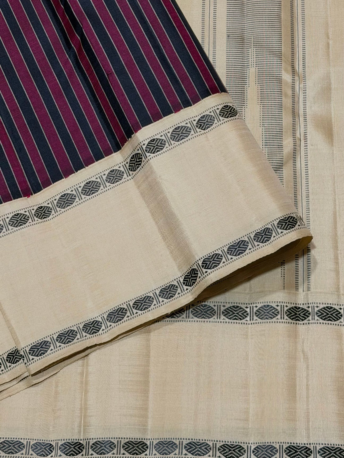 Border detail of the Maroon and Black Striped Premium Zariless Korvai Kanjivaram Saree with Off White Rettapet Rudraksham Borders.