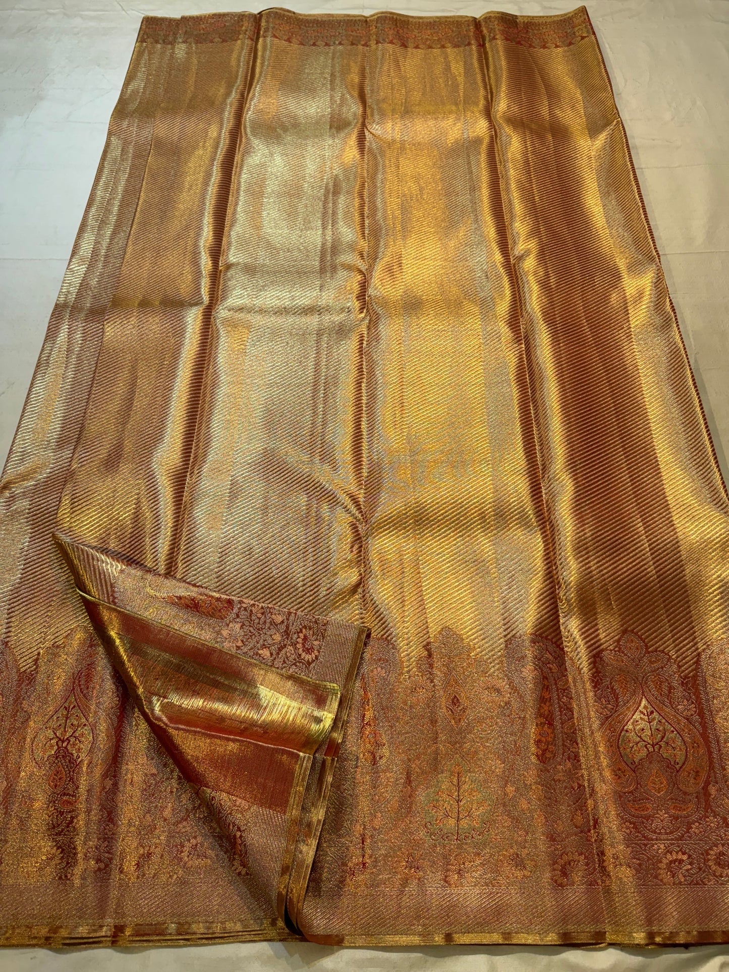 Close view of fine diagonal antique-gold zari ribbing on Rust Gold Kanjivaram silk.