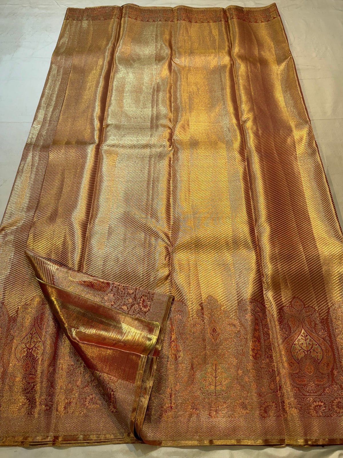 Close view of fine diagonal antique-gold zari ribbing on Rust Gold Kanjivaram silk.