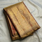 Rust Gold Kanchipuram silk saree with continuous fine diagonal antique-gold zari ribbing.
