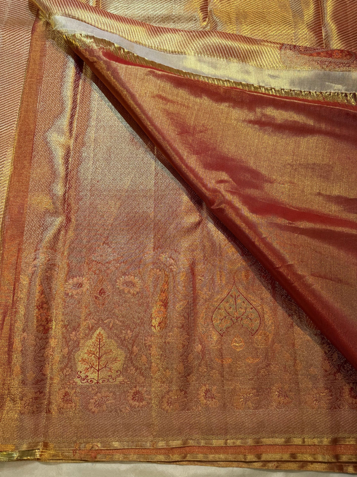 Banarasi-style antique-gold pallu with paisley and floral zari registers.