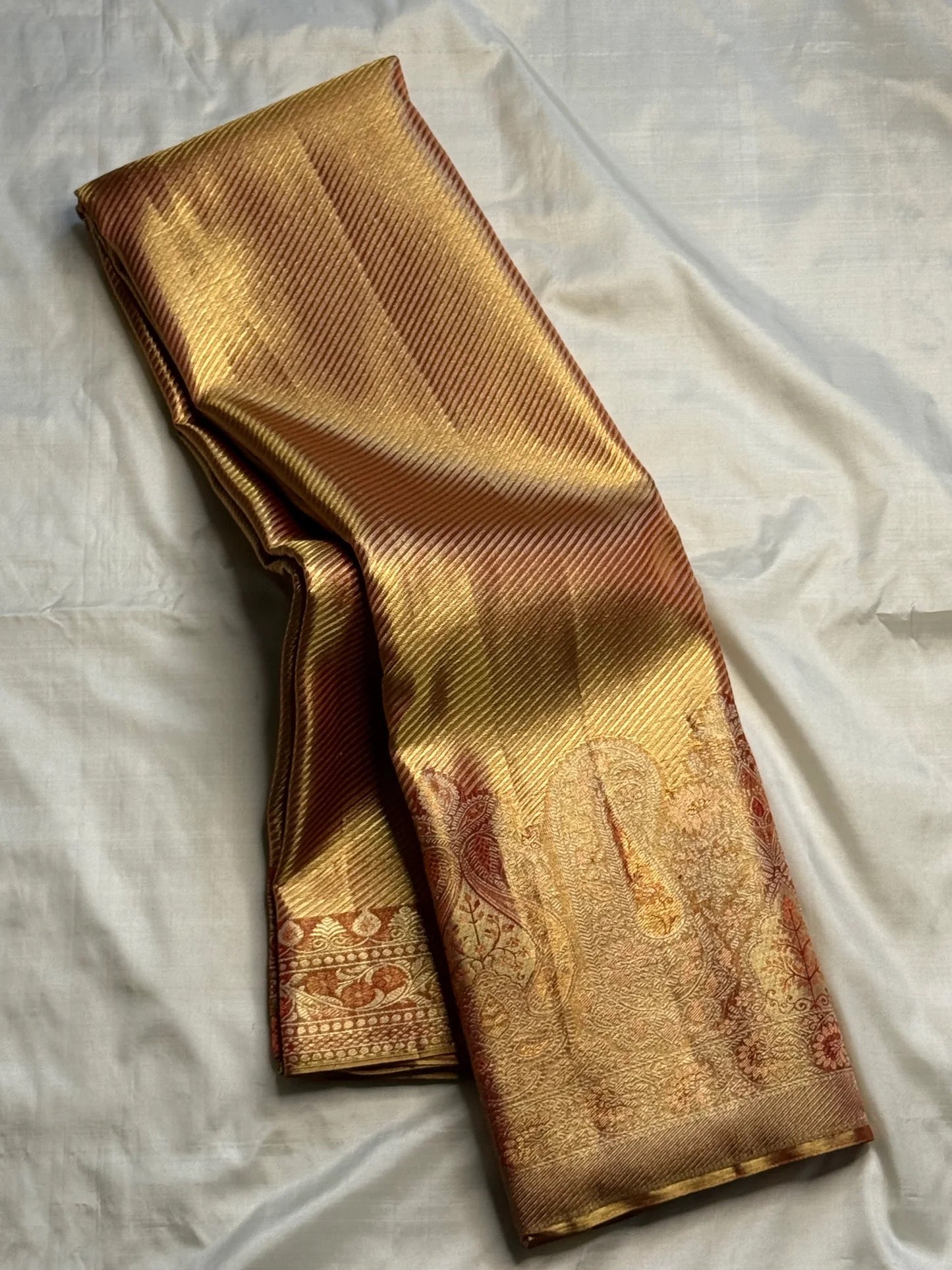 Rust Gold pure silk Kanjivaram Butta fusion saree with Banarasi-style zari weaving.