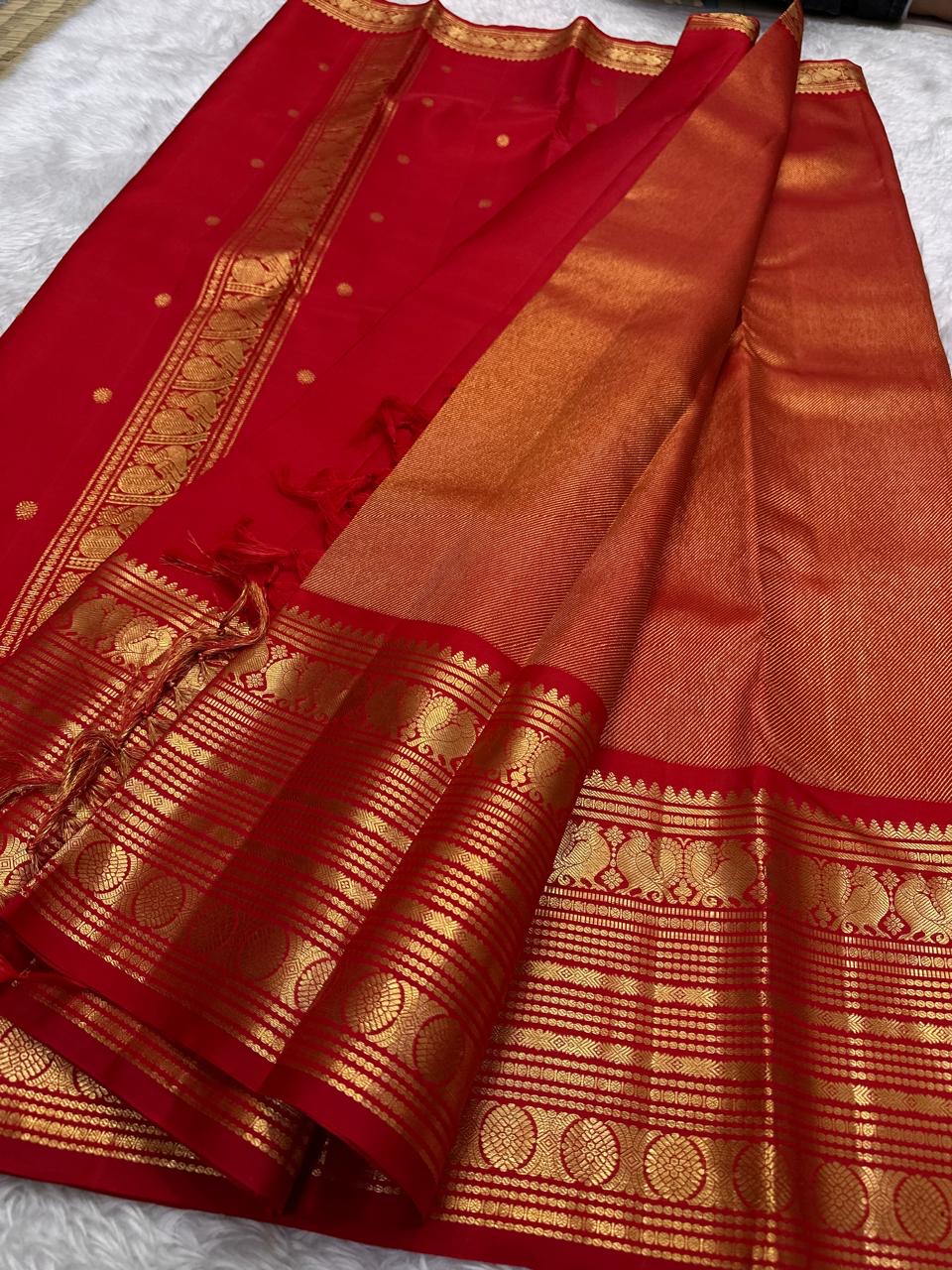 Rust orange and arakku red handwoven pure silk Kanjipuram saree with Korvai Vairaoosi diagonal zari stripe body and ornate antique gold zari border overview