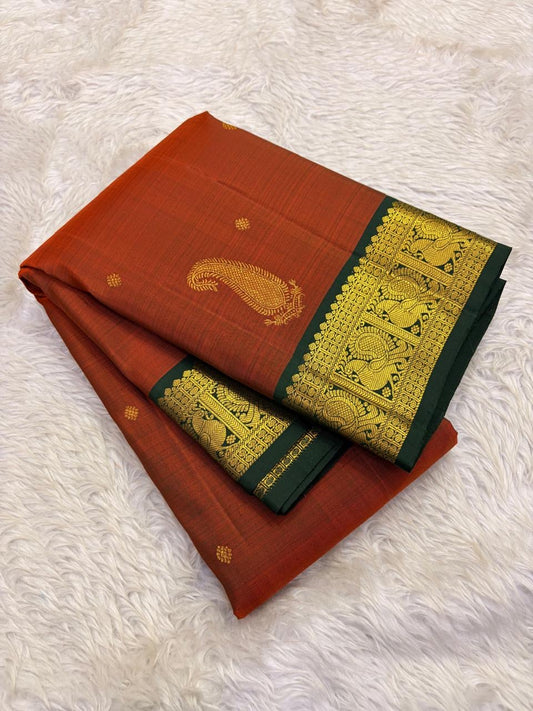 Close-up of rust orange Kancheepuram silk saree body with scattered maanga butta in gold zari — Idam Living