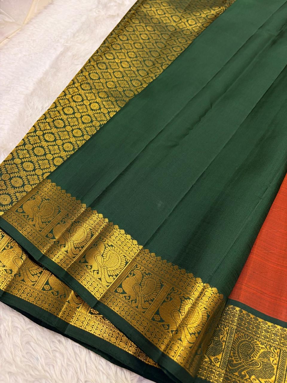 Rust orange Kancheepuram pure silk saree with maanga butta and mayil border on banana leaf — Idam Living