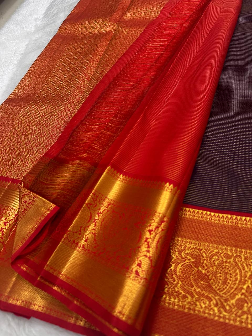 Orange Kanjivaram saree with deep navy contrast border