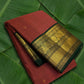 Rust orange Kanchipuram silk saree with gold zari korvai and deep forest green border