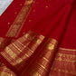 Rust orange Kanjipuram silk saree body close-up showing Vairaoosi-style rich diagonal zari stripe bands across the pure mulberry silk