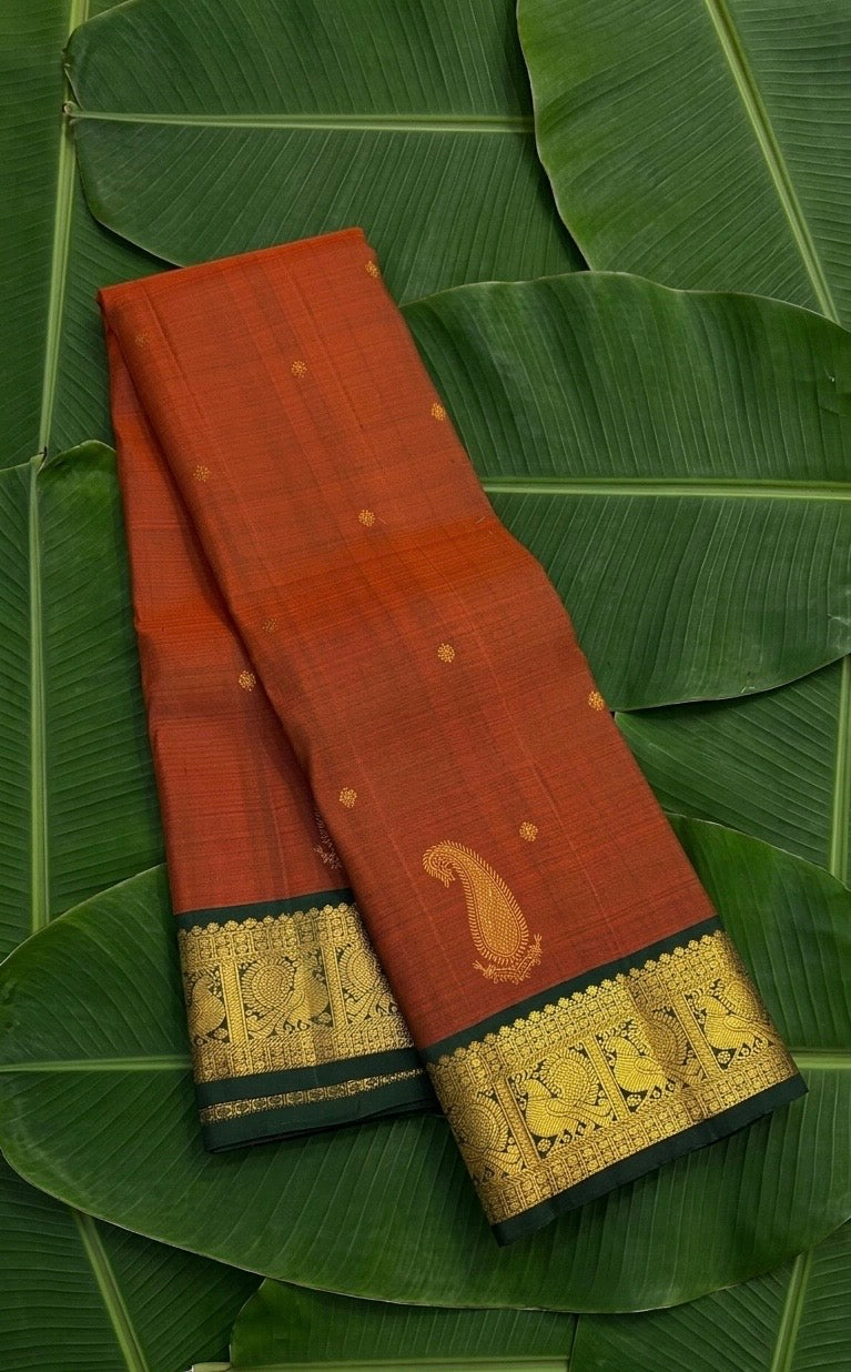Rust orange handwoven Kanchipuram pure silk saree with maanga butta and forest green mayil border — Idam Living