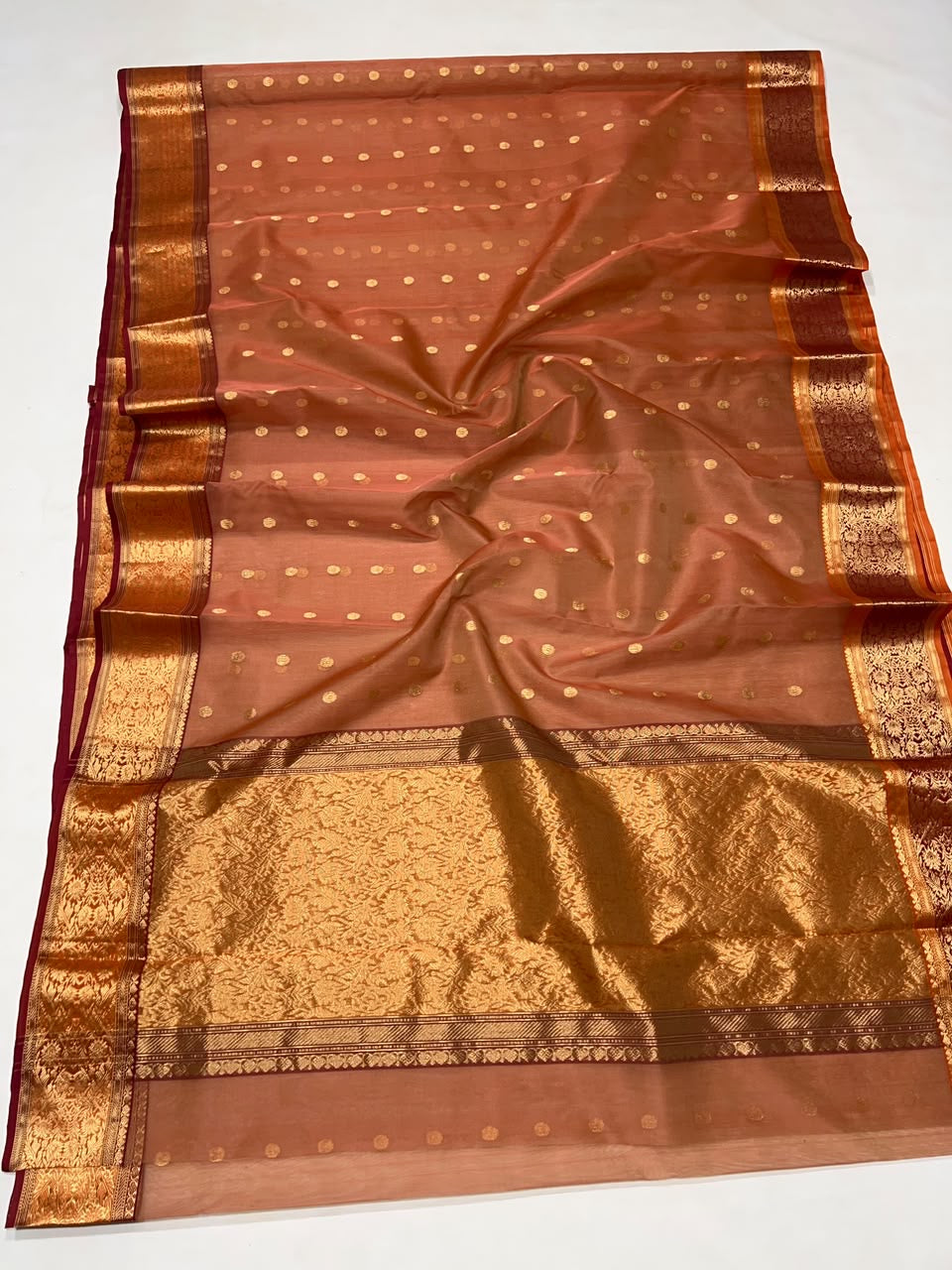 Rust terracotta Katan Silk Chanderi saree draped to show body and border