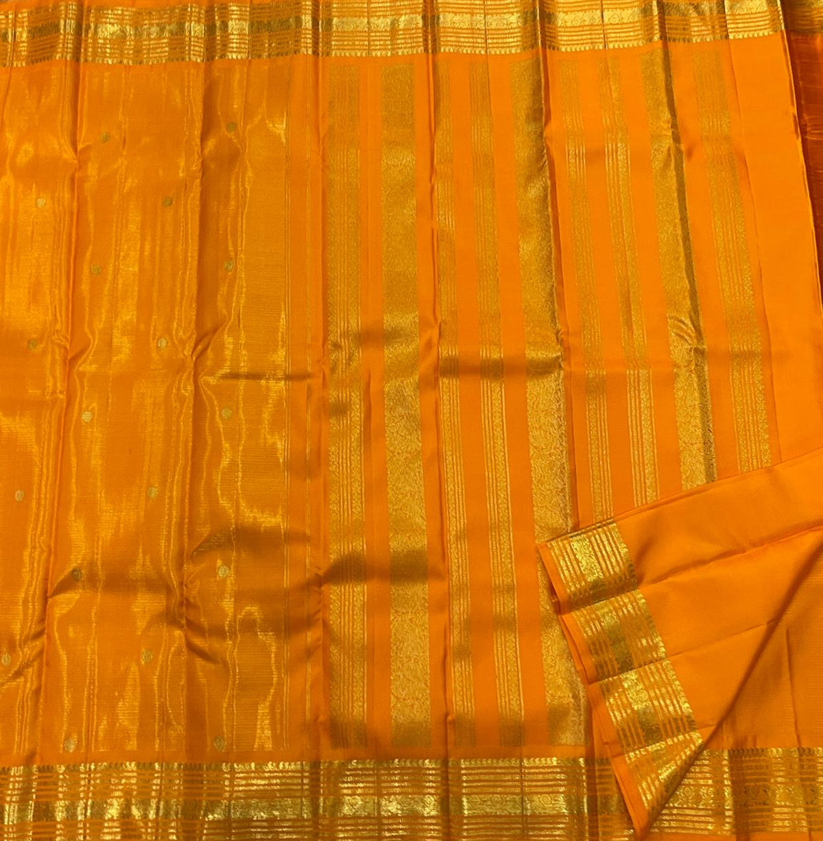 Close view of fine continuous Vairaoosi zari lines on Saffron Orange silk.