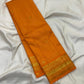 Saffron Orange silk saree with spaced warm gold zari buttas.