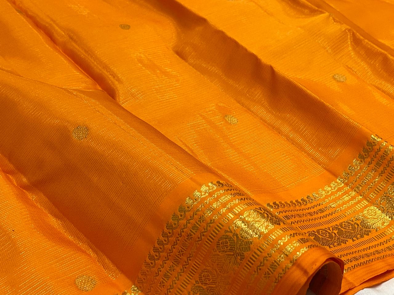 Saffron Orange pure silk Kanchipuram Vairaoosi saree with fine directional zari lines.