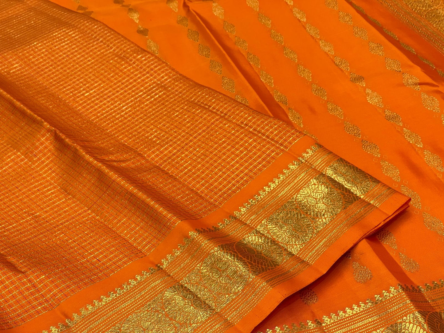 Saffron Orange Kanchipuram silk woven with fine intersecting gold Zari Kattam checks.
