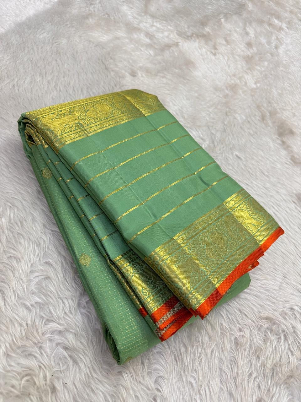 Close view of traditional antique-gold zari motifs woven on Sage Green Kanjivaram silk.