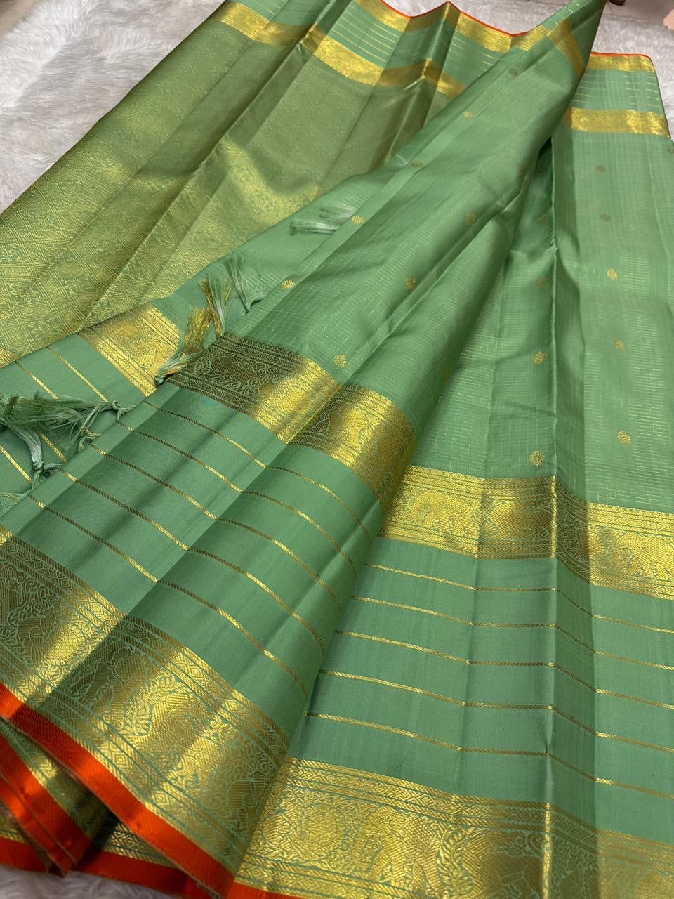 Sage Green pure mulberry silk Varisaipet saree with gold zari lines and Burnt Orange selvedge.
