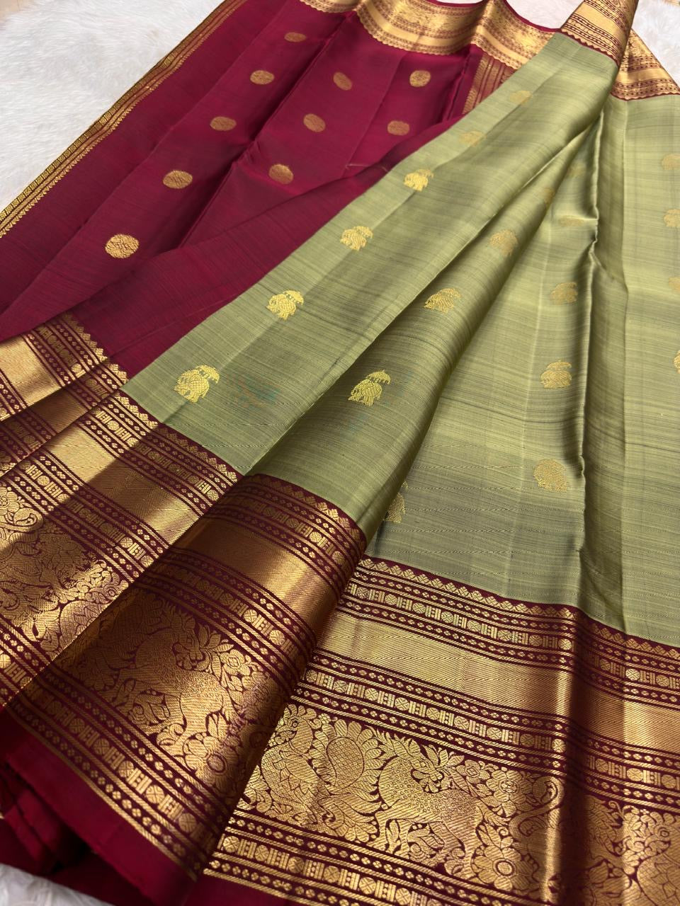 Deep red Vanasringaram gold zari border of sage green Kanjipuram pure silk saree with elephant procession motif