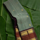 Sage green handwoven Kanchipuram pure silk saree with mayil chakram butta and coffee brown korvai rettapet border — Idam Living