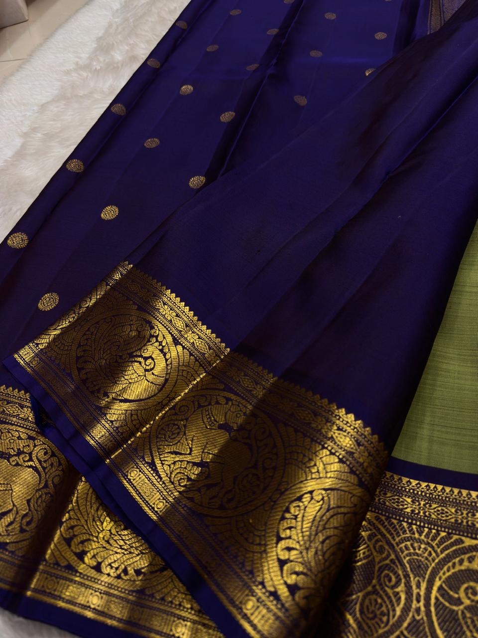Sage green Kanchipuram silk saree with royal purple border close-up
