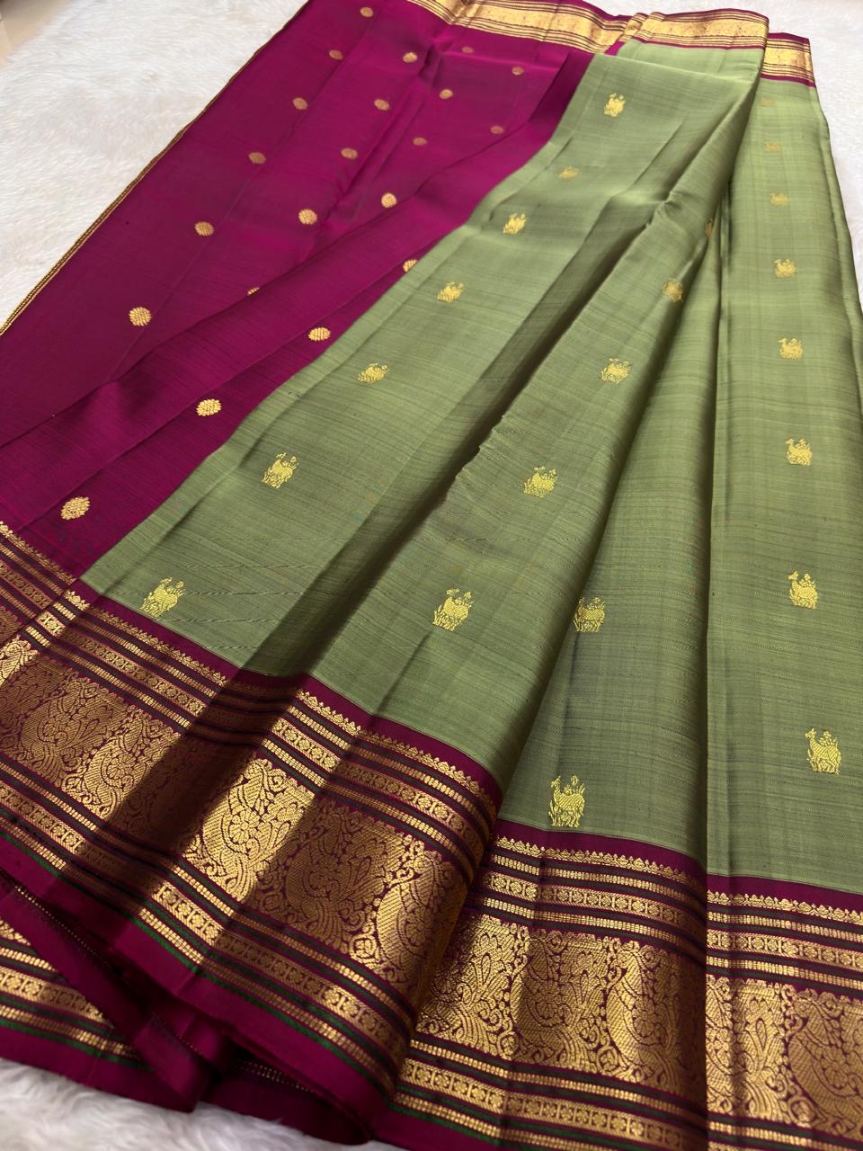 Sage green Kanchipuram silk saree with traditional gold zari border detail