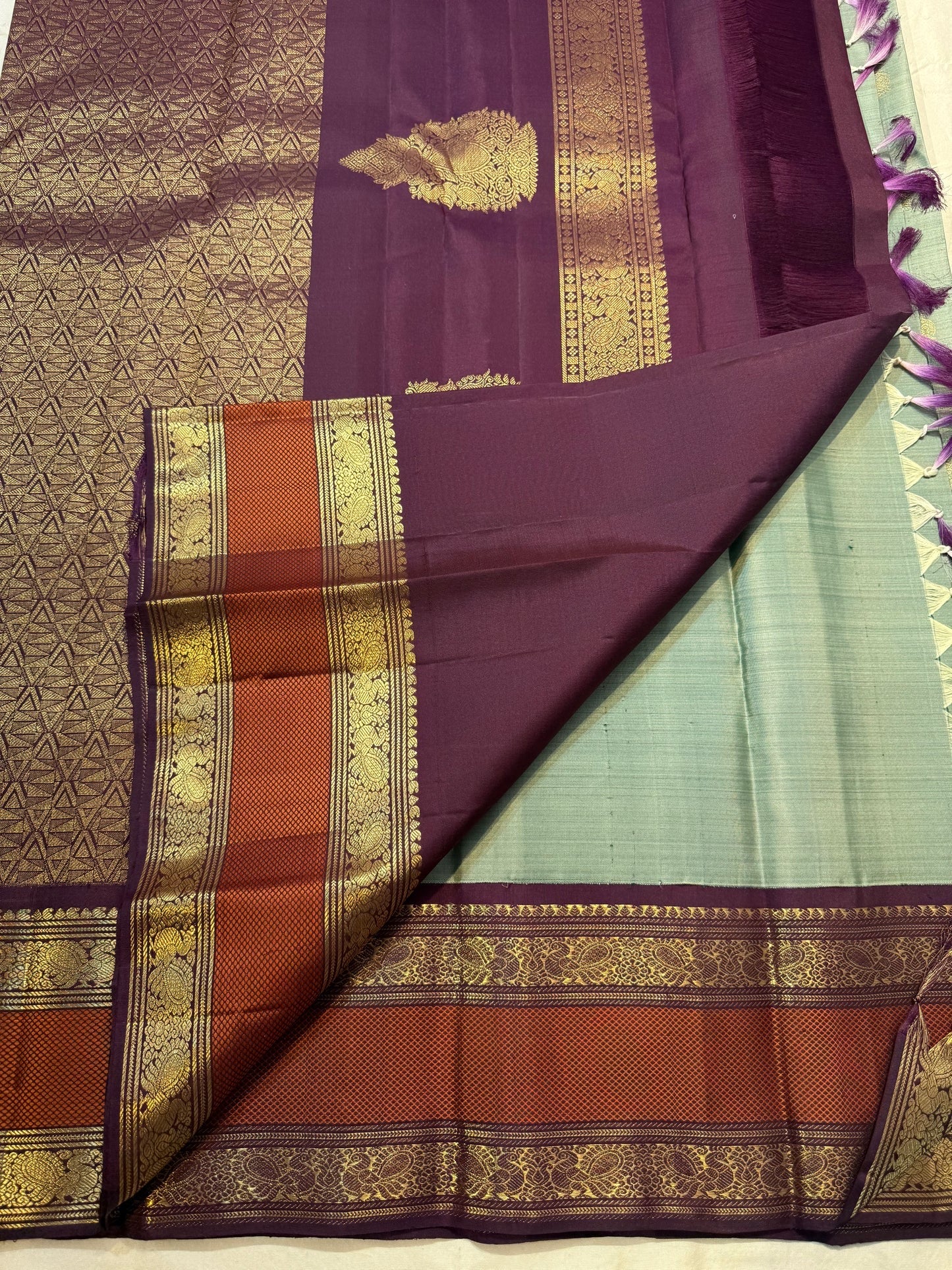 Mayil chakram butta in gold zari close-up on sage green Kanjipuram pure silk saree — Idam Living