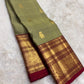 Handwoven sage green Kanjipuram pure silk saree with gold zari Yaanai Ambari Butta and deep red Vanasringaram border
