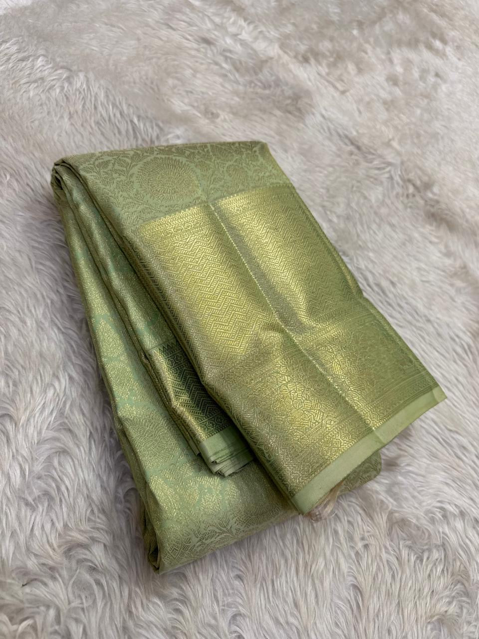 Gold floral jaal butta motif detail on sage green silk