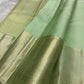 Gold zari border detail on sage green Kanjivaram saree
