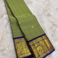 Sage green handwoven pure silk Kanchipuram saree with royal purple Korvai border