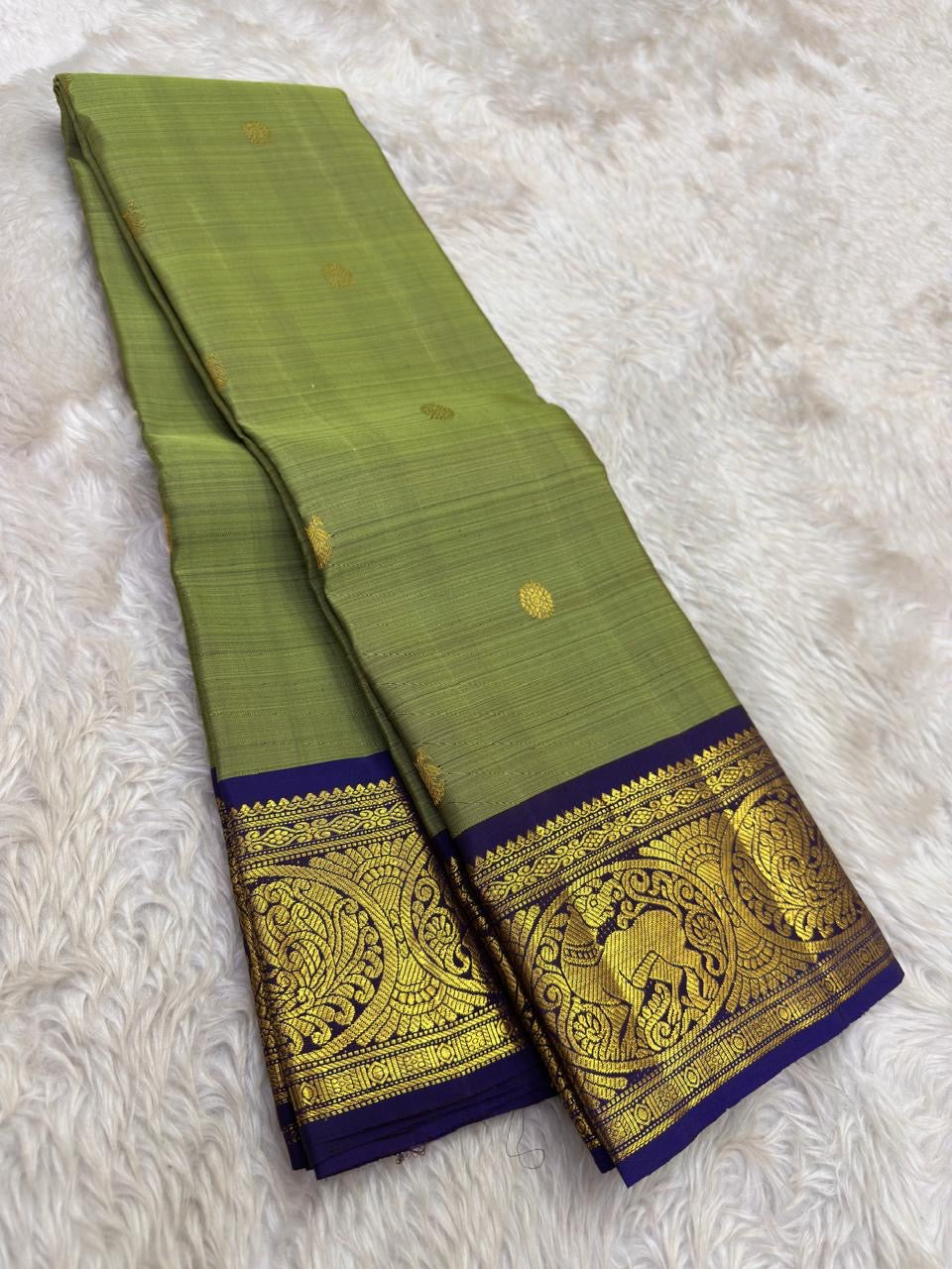 Sage green handwoven pure silk Kanchipuram saree with royal purple Korvai border