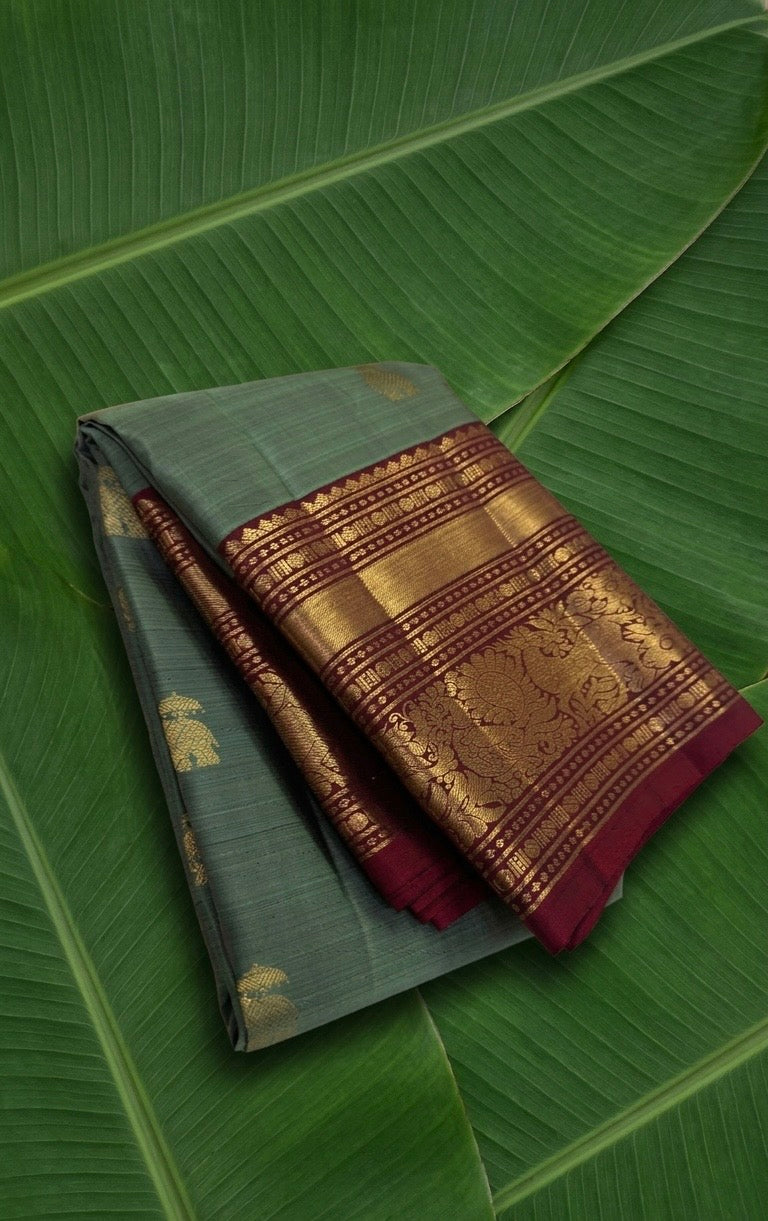 Sage green Korvai Kanjivaram silk saree with burgundy red border and yaanai ambari butta – front drape view