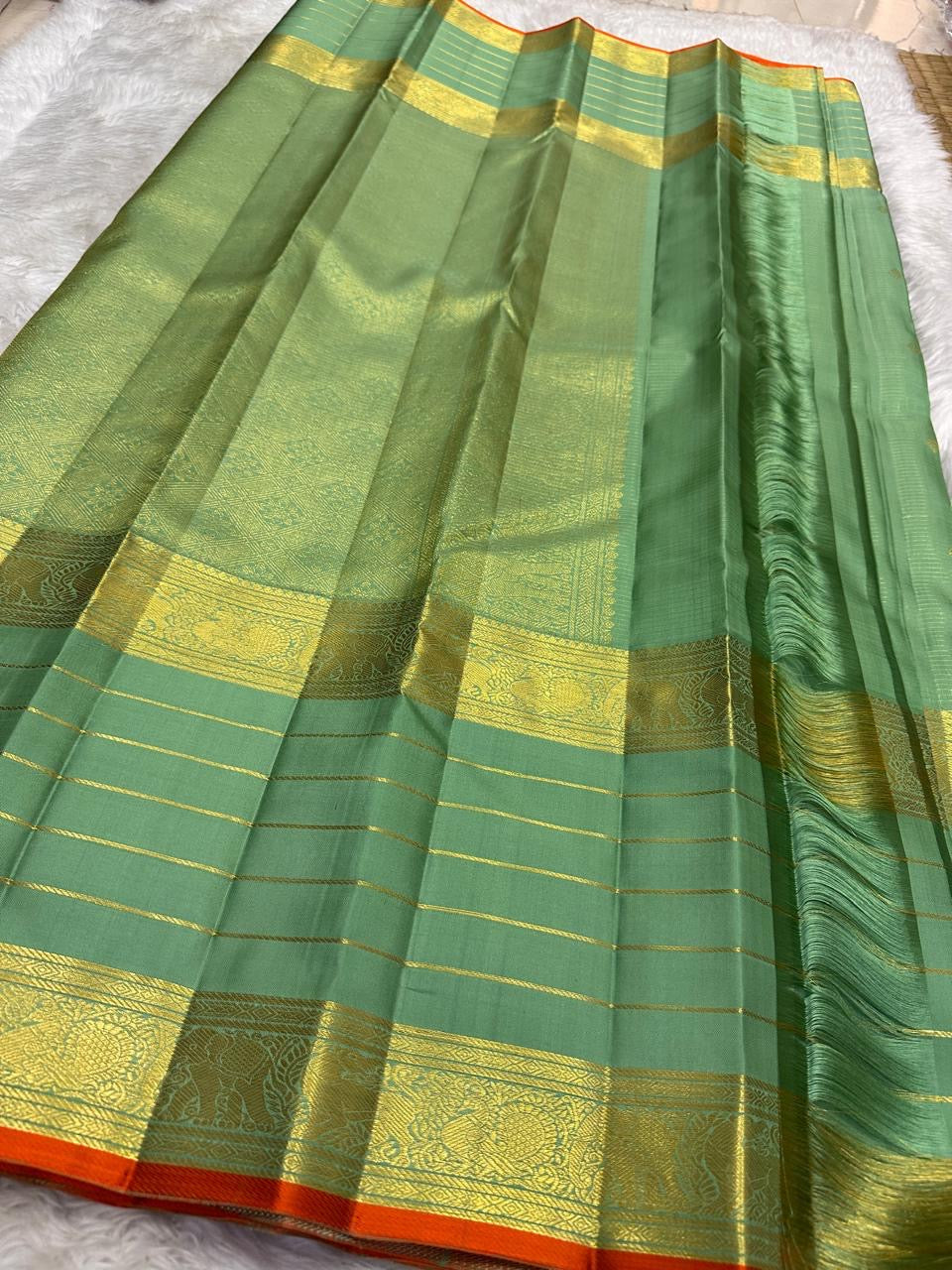 Sage Green pure silk Kanjivaram Varisaipet saree with antique-gold traditional zari border.