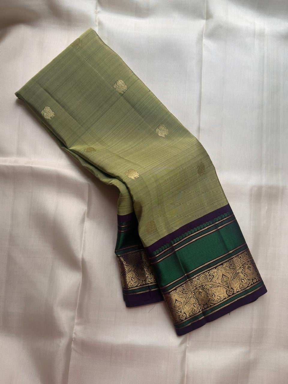 Sage olive green pure silk KanchiPattu saree with gold zari Butta motifs, full drape view
