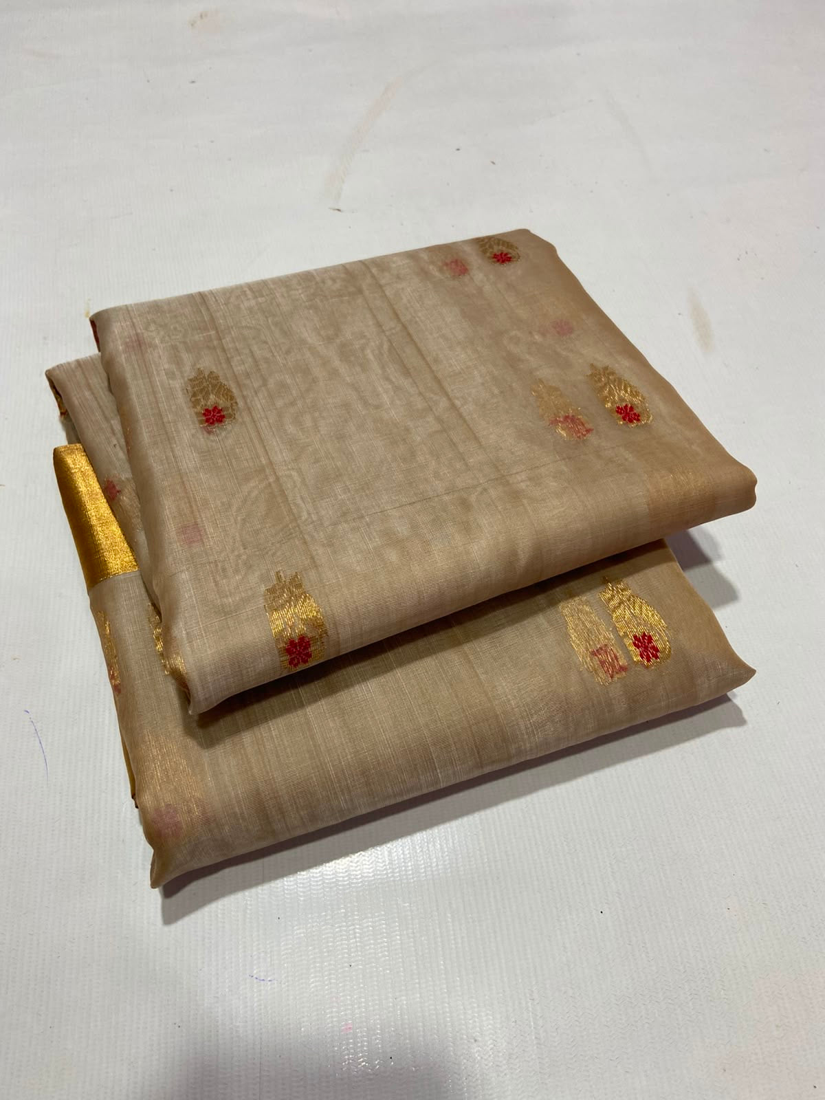 Sandalwood Beige Katan Silk Chanderi saree with gold and red woven buttas, broad gold border and floral gold pallu.