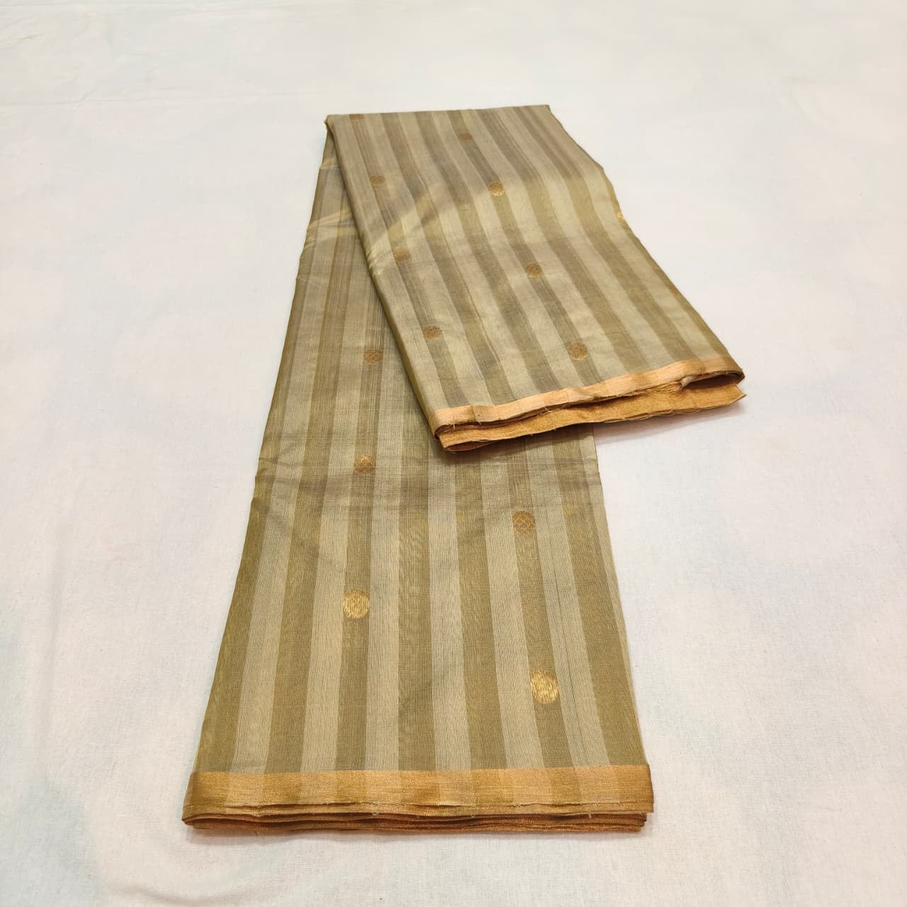 Close-up of antique-gold buttas on the tonal striped Sandalwood Beige Chanderi saree