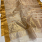 Folded Sandalwood Beige Katan Silk Chanderi saree showing gold border and petite gold buttas with red accents.