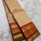 Full view of sandstone beige Kanchipuram silk saree with kamalam butta and Ganga Jamuna korvai border — Idam Living