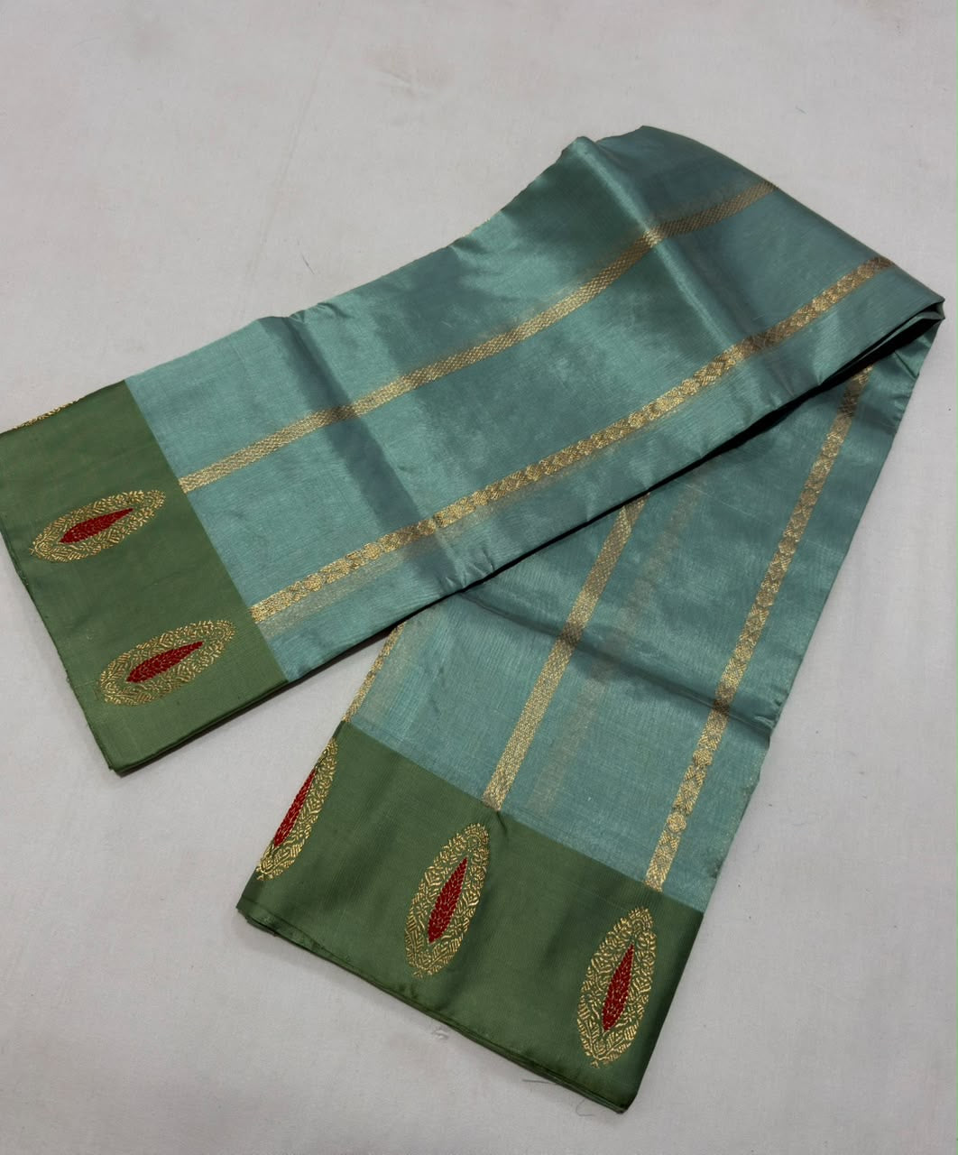 Sage green contrast border with ruby red accented motifs on sea glass blue Chanderi silk