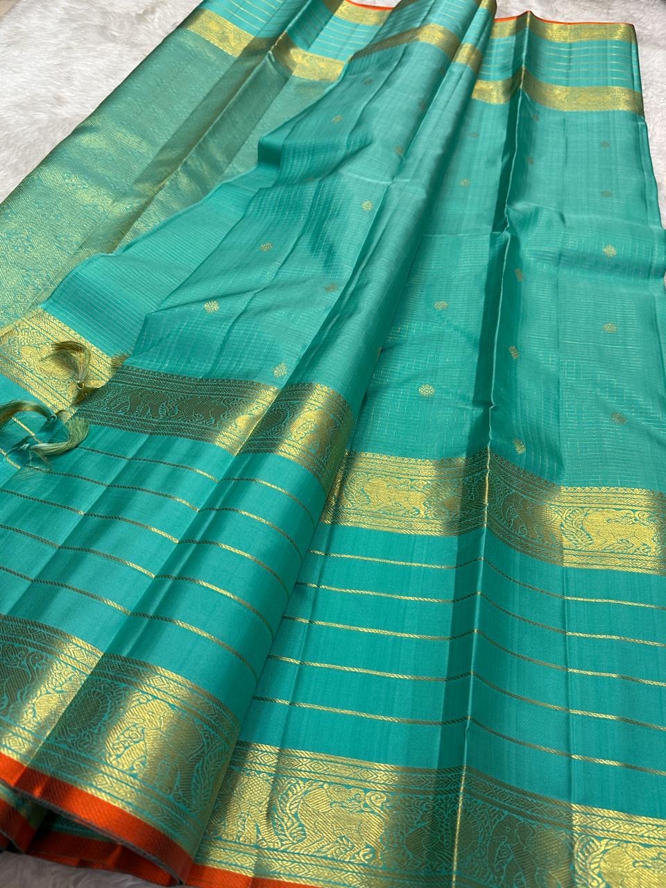 Sea Green pure mulberry silk Varisaipet saree with gold zari lines and Burnt Orange selvedge.
