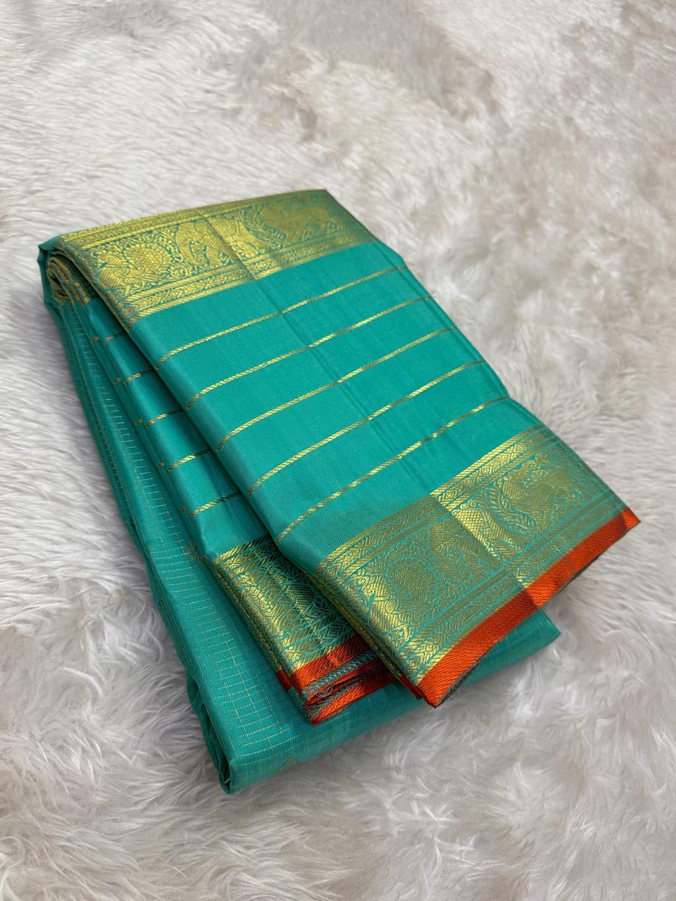 Turquoise Sea Green Kanchipuram silk saree with small spaced antique-gold zari buttas.