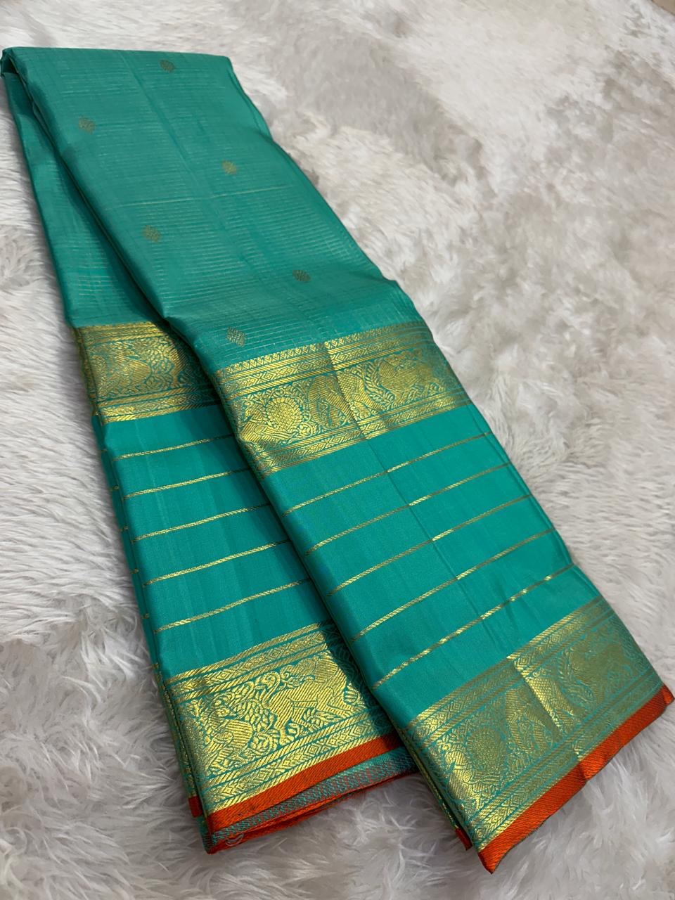 Sea Green pure silk Kanjivaram Varisaipet saree with antique-gold traditional zari border.
