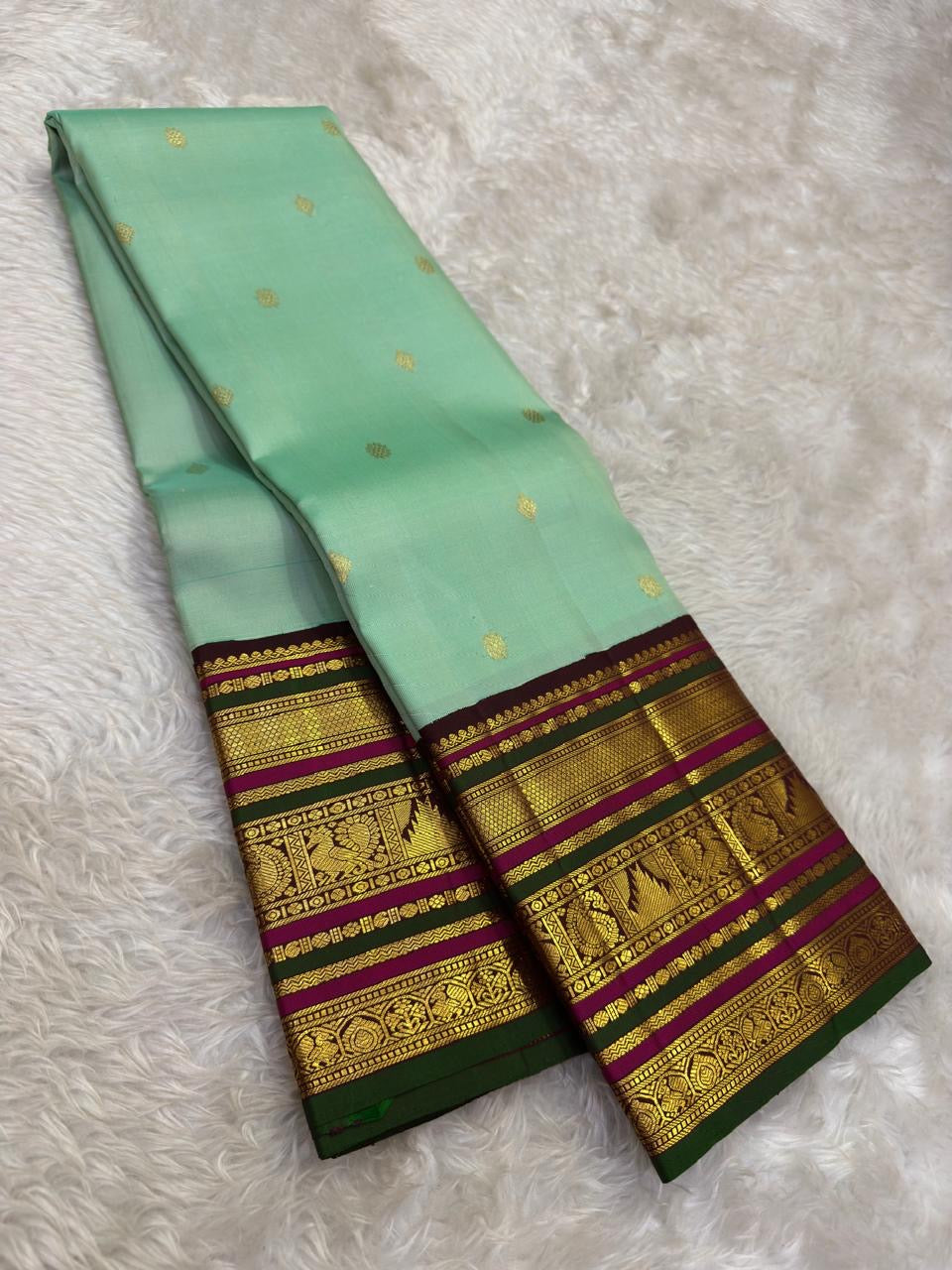 Deep green and magenta Varisaipet border with peacock and elephant zari bands in antique gold