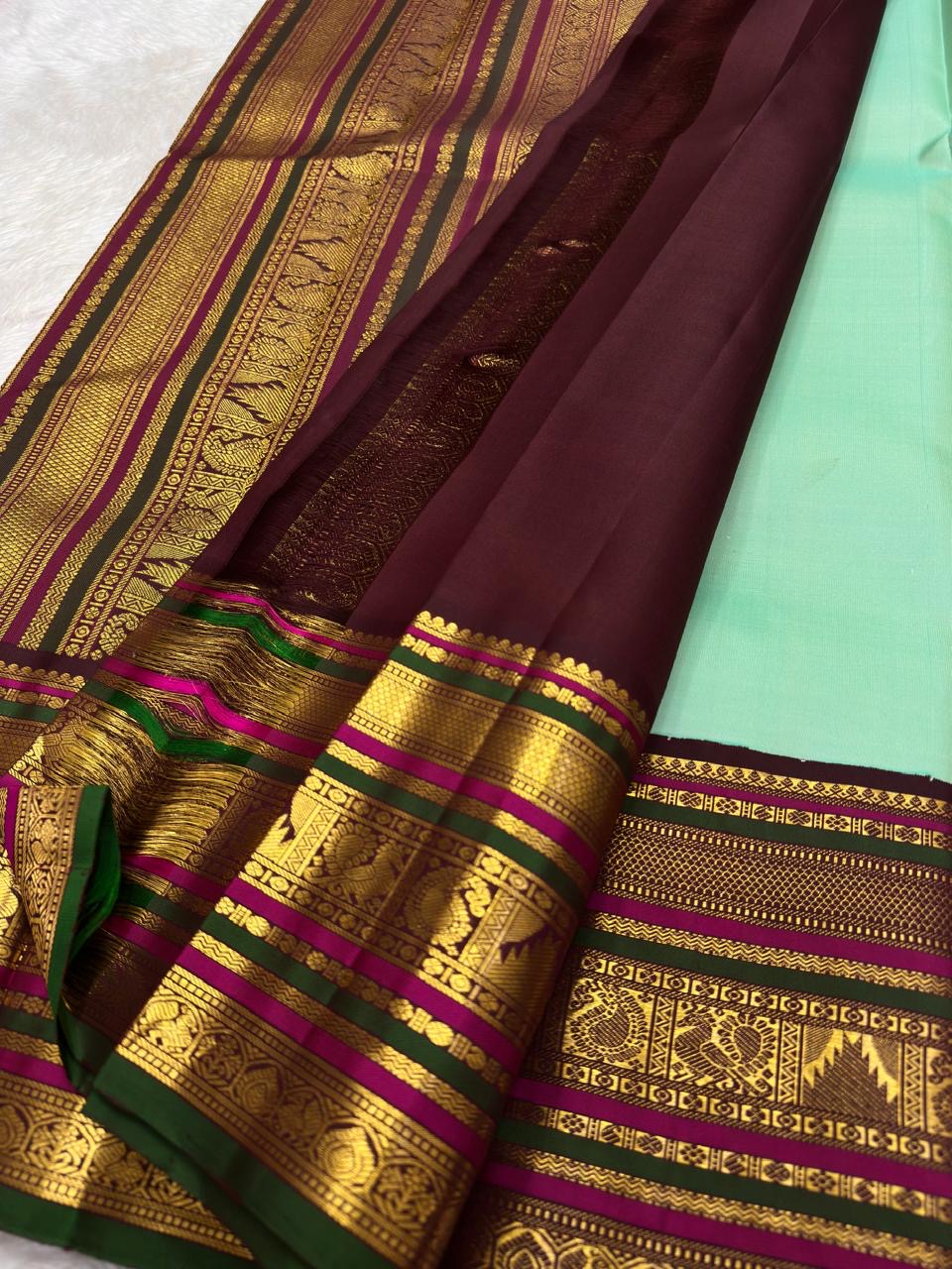 Deep green pallu with full ornate Varisaipet array — elephant, peacock, and floral zari motifs