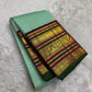 Seafoam green Kanchi Pattu saree folded to show contrast deep green and magenta Varisaipet border