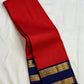 Deep vibrant red handwoven Kanchipuram silk saree with neelam-blue border and pallu.