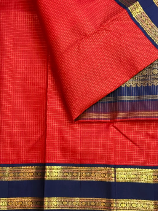 Deep vibrant red Pure Silk Kanchipuram Rettapet saree with neelam-blue border and luminous zari kattam.